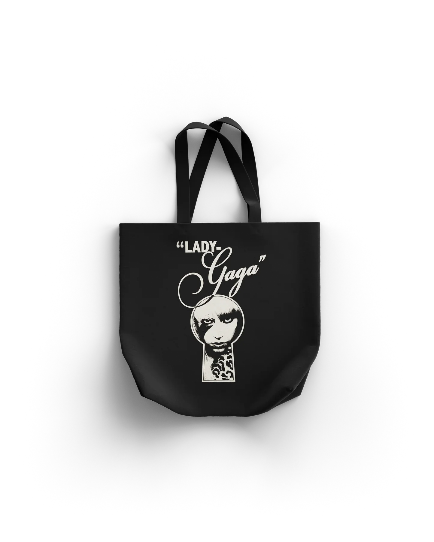 Lady Gaga Keyhole Boys tote bag front featuring keyhole face graphic with “Lady Gaga” script text on black canvas