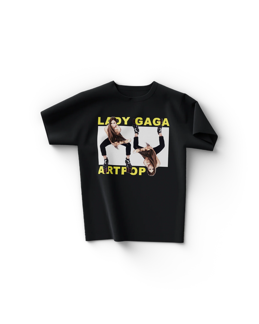 Black Lady Gaga merch t shirt front view with yellow "LADY GAGA ARTPOP" text and mirrored leg pose graphic in center