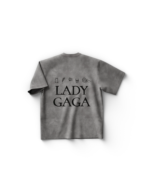 Grey Lady Gaga t shirt back view with large "Lady Gaga" text and small symbolic icons above