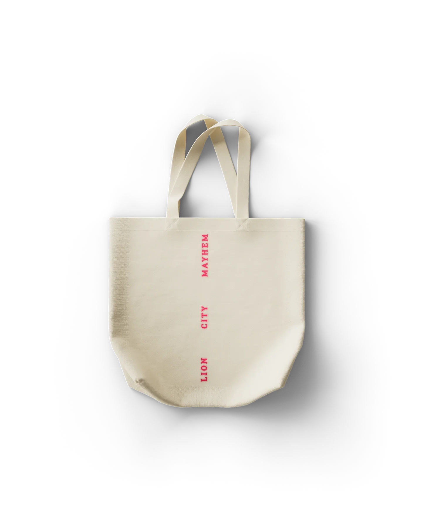 Lady Gaga Singapore tote bag back featuring vertical “Lion City Mayhem” text in pink on cream canvas