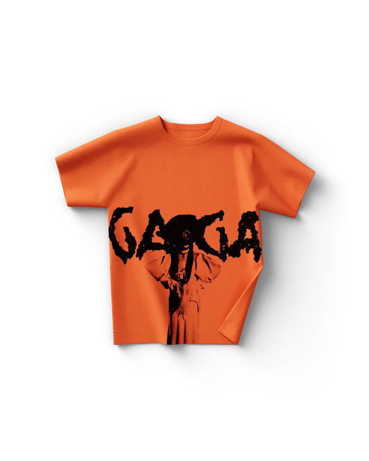 Lady Gaga orange pose t-shirt front featuring bold “Gaga” text with dramatic black silhouette graphic design